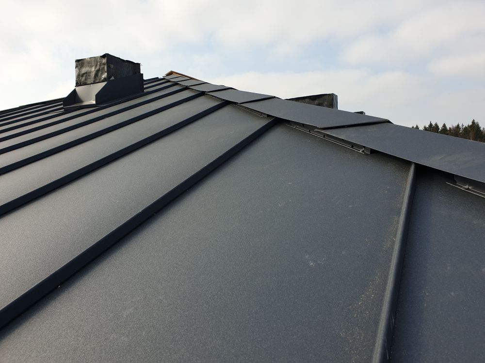 A Black Roof With a Chimney on Top of It — Sheps Roofing Service Pty Ltd In Wollongong, NSW