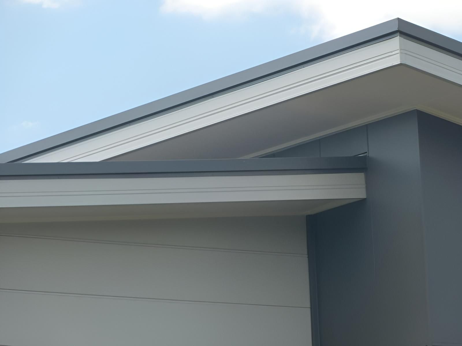 A Close Up of the Roof of a House With a Blue Sky in the Background — Sheps Roofing Service Pty Ltd In Kiama, NSW