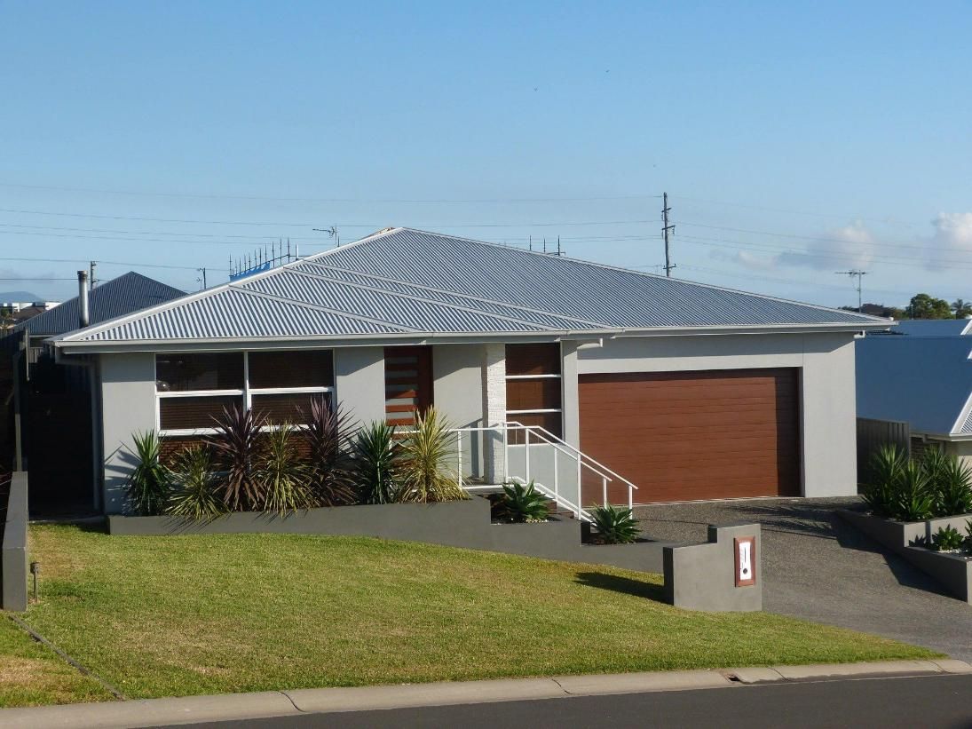 A White House With a Brown Garage Door — Sheps Roofing Service Pty Ltd In Albion Park, NSW