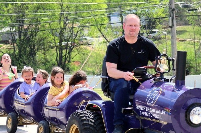 Children riding the purple train at a French Broad Valley Baptist Church kids event