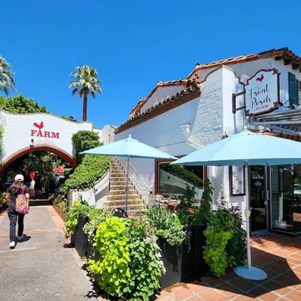 A bright sunny day at the Farm and Local Perch restaurant with a person walking towards the entrance.