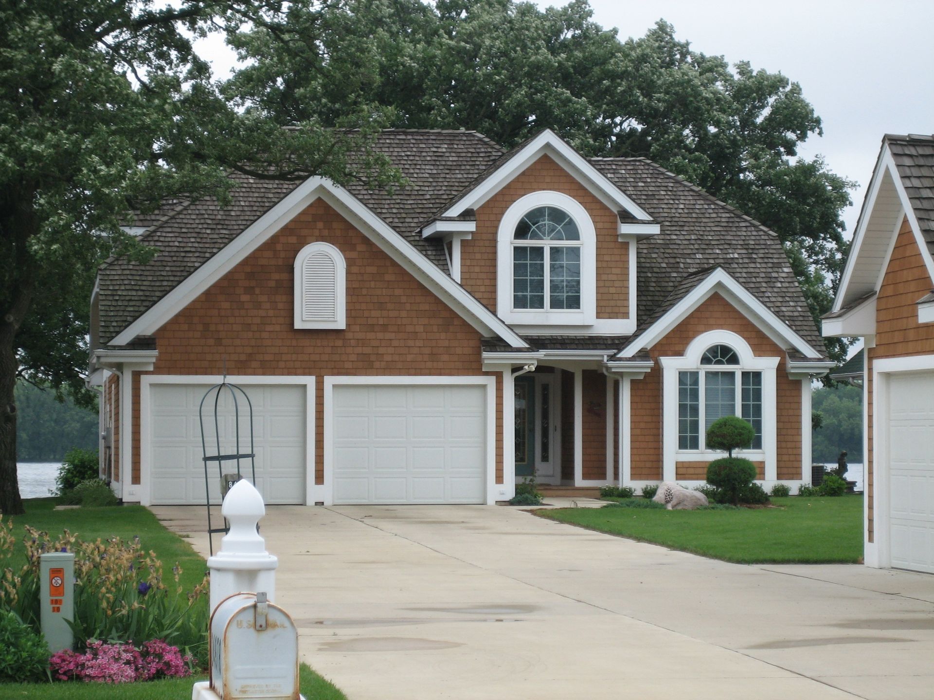 Large white two-story house with columns.