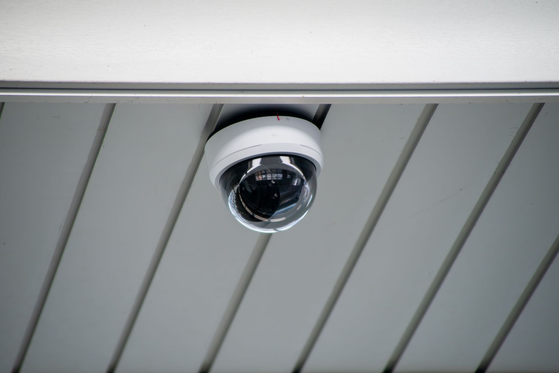 Close-up of a Hikvision or Dahua dome camera freshly mounted, hardware branding visible. Close-up of a Hikvision or Dahua dome camera freshly mounted, hardware branding visible.