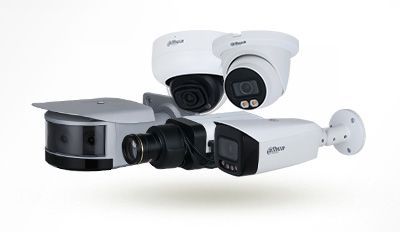 White security camera mounted on a wall, pointed forward with a blurred background. White security camera mounted on a wall, pointed forward with a blurred background.