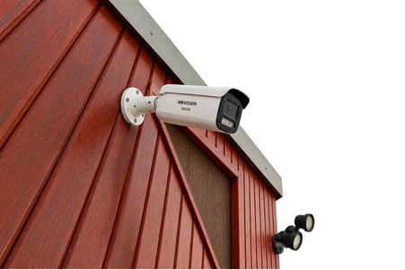 Wide exterior shot of a completed commercial install — shopfront or warehouse, multiple cameras visible in one frame. Wide exterior shot of a completed commercial install — shopfront or warehouse, multiple cameras visible in one frame.