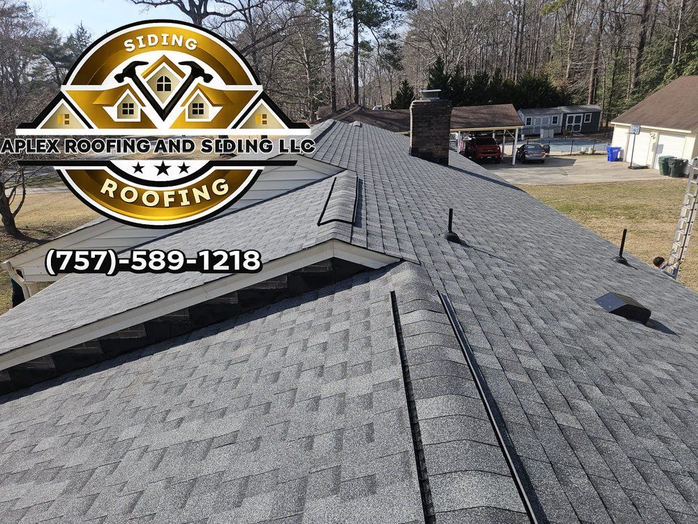 Roofing company logo over a drone view of a gray shingle roof with multiple vents and dormers
