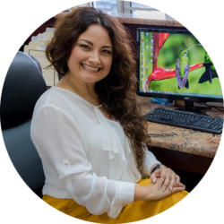 SUSAN MARTINEZ Susan Martinez, sitting at a desk.