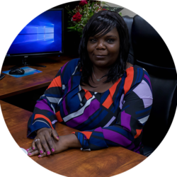 RHONDA MOORE Rhonda Moore, sitting at a desk.