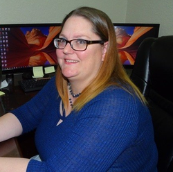 CHRISTINA WOOLDRIDGE Christina Wooldridge, sitting at a desk.