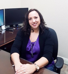  Vanessa McQuade, sitting at a desk.