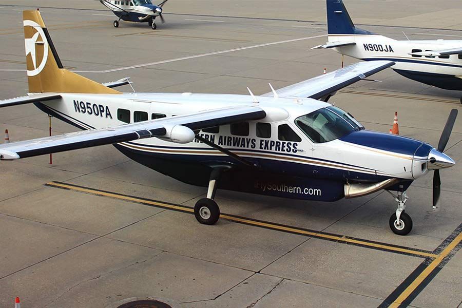 Southern Airways Express Cessna Caravan parked on the ramp with gold and blue livery.