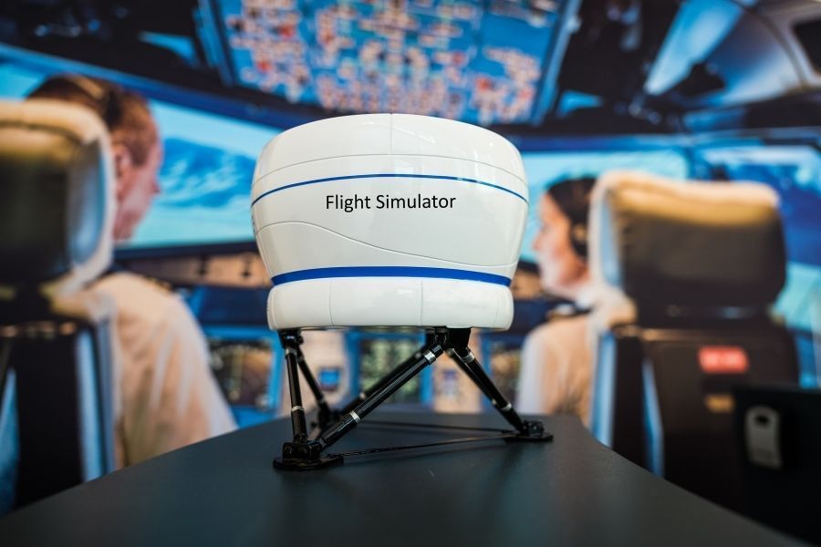 two student pilots in a flight simulator for training