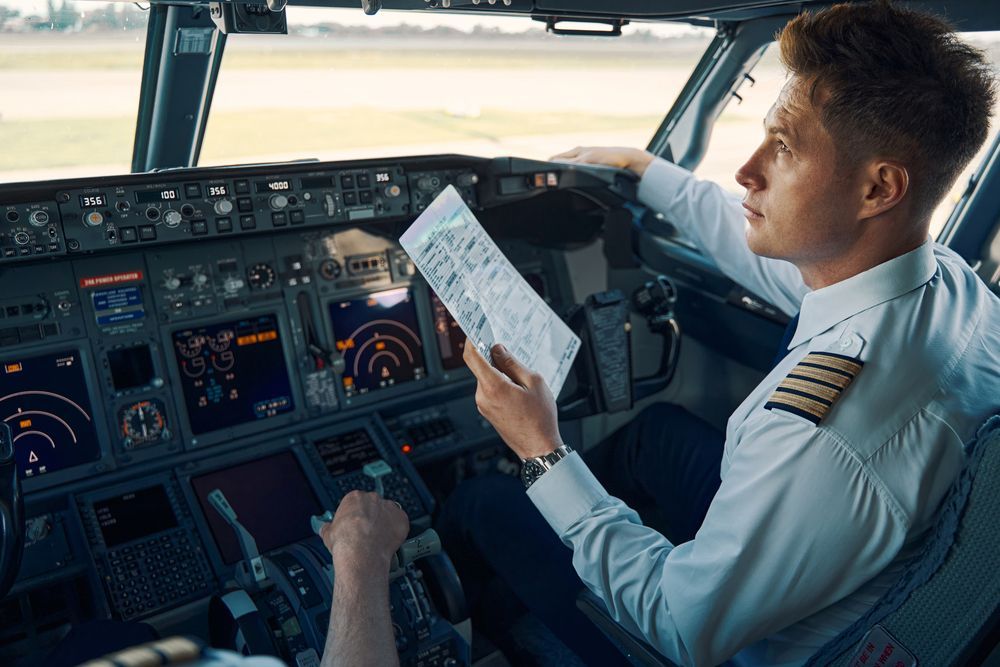 A pilot checking his gauges and control panel.