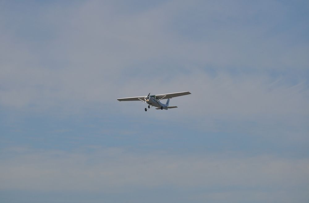 A small plane flying in the sky.