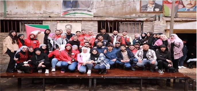 A group of people are posing for a picture in front of a building.