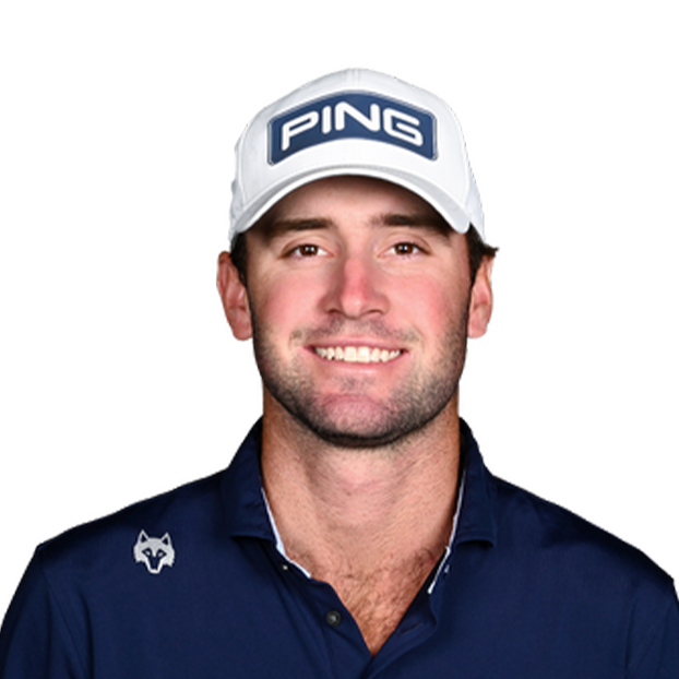 Smiling man in a white PING cap and navy polo shirt against a white background