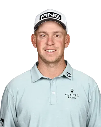 Man in a light blue Ping cap and polo shirt, smiling against a white background