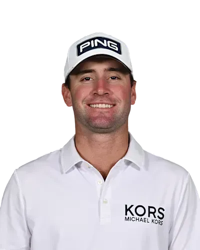 Smiling golfer in white PING cap and KORS shirt against a white background