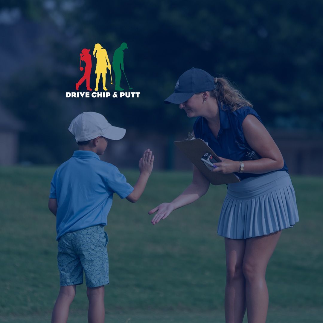 Golfer in green shirt and white cap posing with arms raised, holding a club at Drive Chip & Putt event