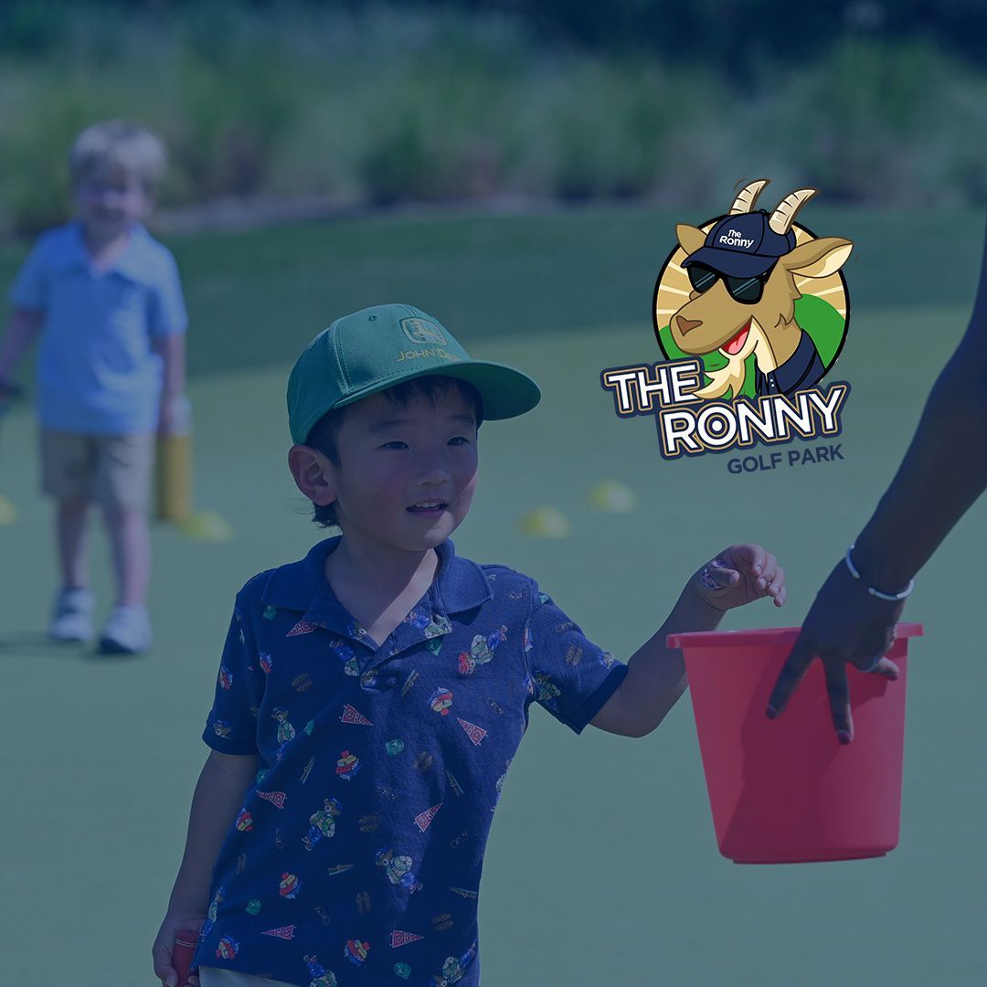 Five children and an adult posing with golf clubs on a green at an outdoor event