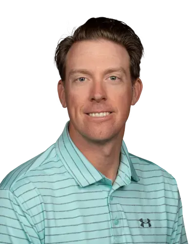 Portrait of a man in a light blue striped polo shirt against a white background