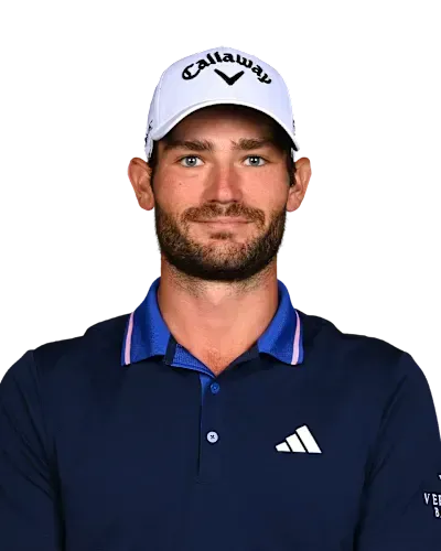 Man in white cap and navy polo shirt, facing forward against a plain white background.