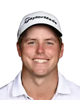 Smiling golfer in a white TaylorMade cap and white polo shirt