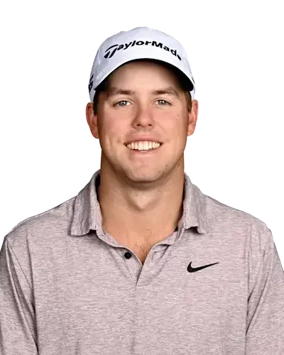 Smiling man in a white cap and light gray polo shirt against a white background