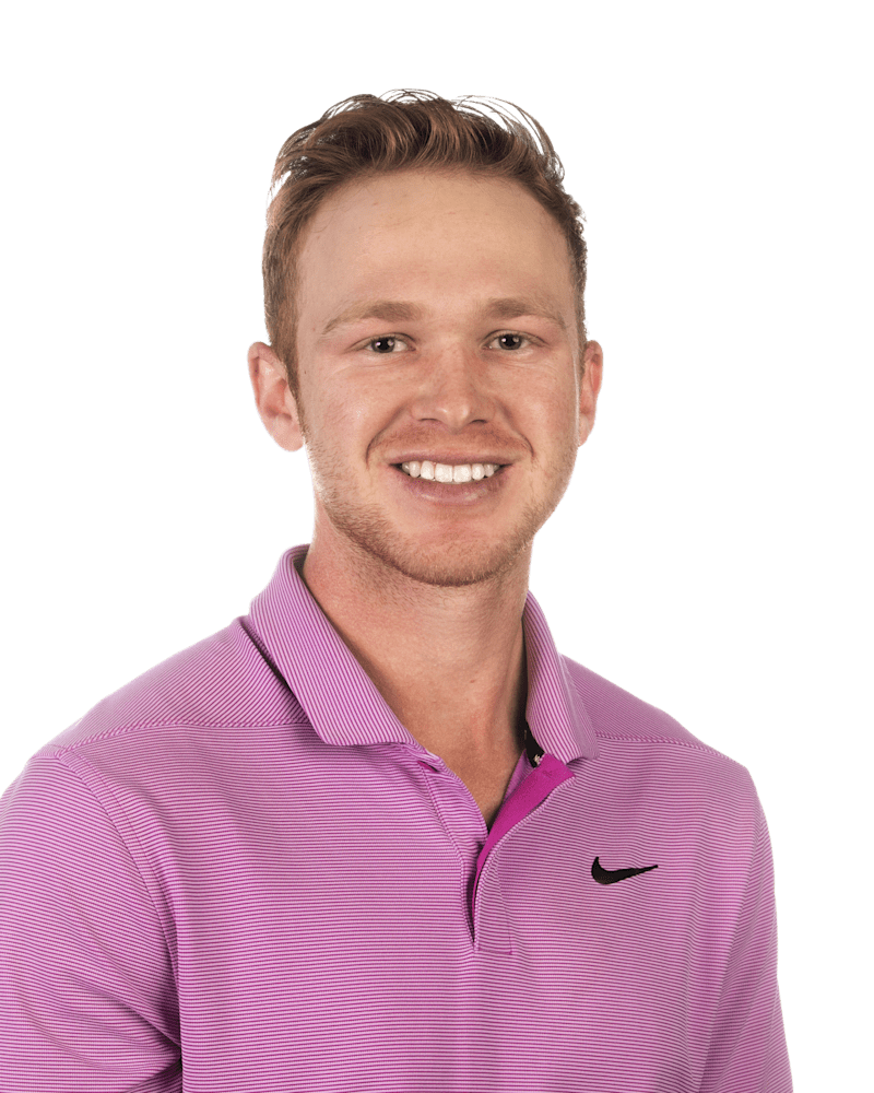 Smiling person in a pink striped polo shirt against a white background
