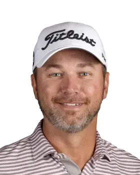 Smiling man in a white Titleist cap and striped polo shirt against a white background