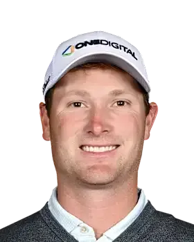 Smiling man in a white cap and dark sweater on a plain background