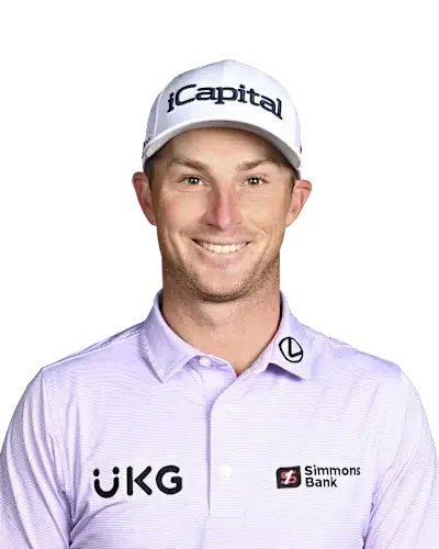 Smiling golfer in a white cap and light purple sponsor polo against a plain white background