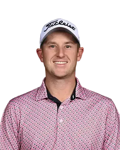 Smiling man in a white Titleist cap and pink patterned golf shirt on a white background
