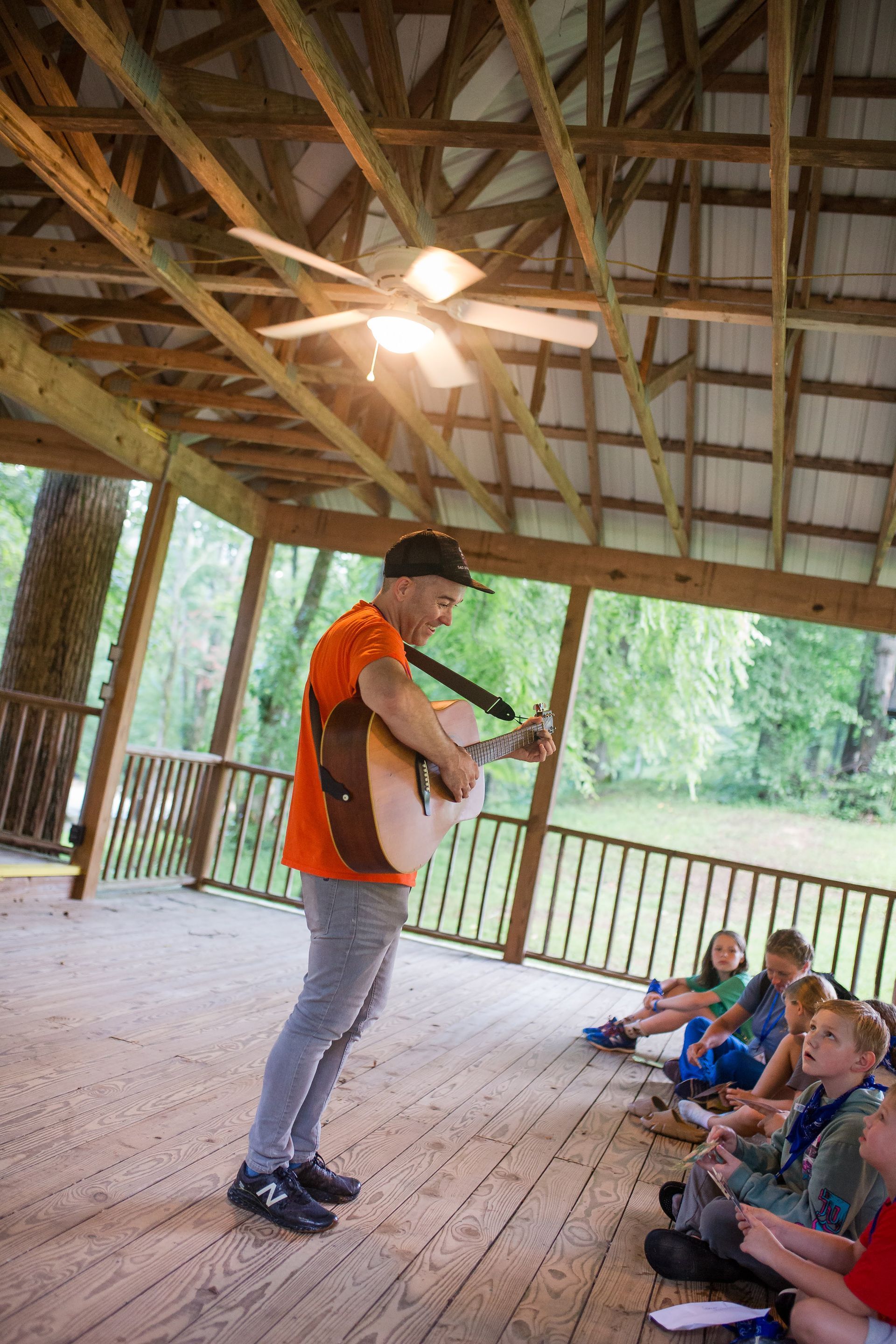 Camp Erin volunteer playing guitar 