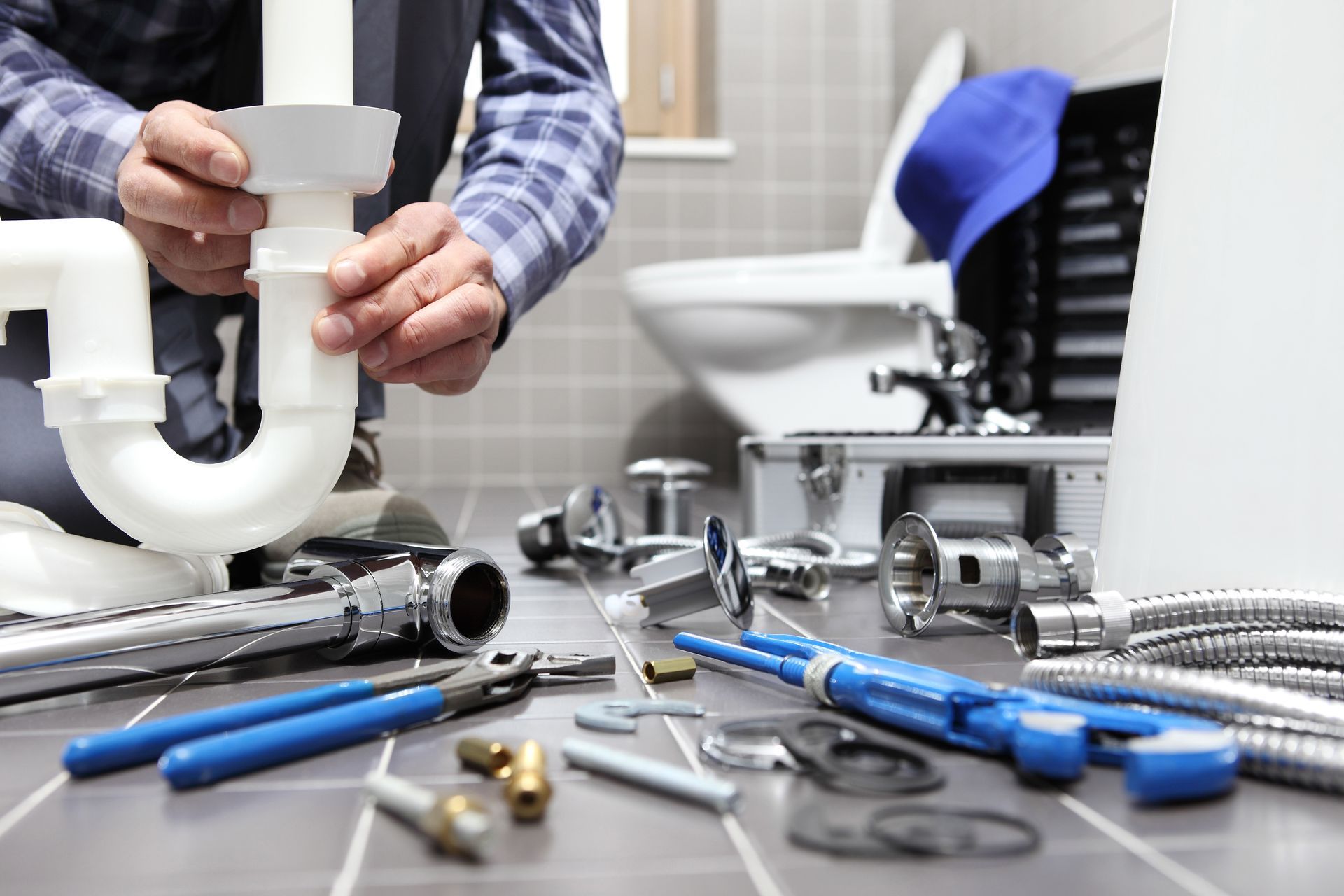 Plumber at work in a bathroom.
