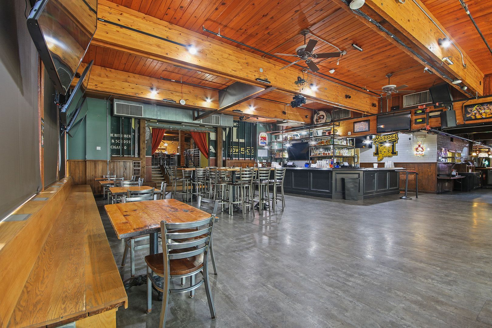 A large room with tables and chairs in a restaurant.