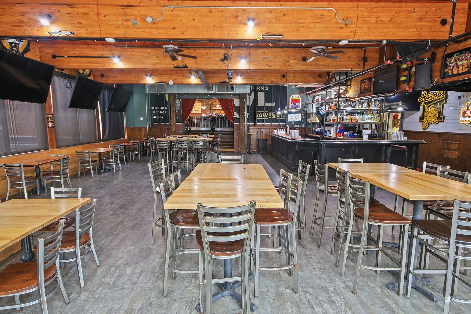 A restaurant with tables and chairs and a pepsi sign on the wall