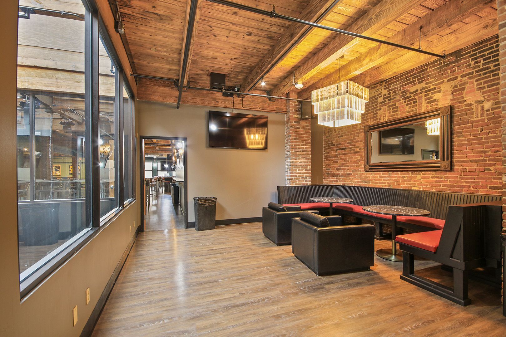 A large room with a lot of furniture and a brick wall.
