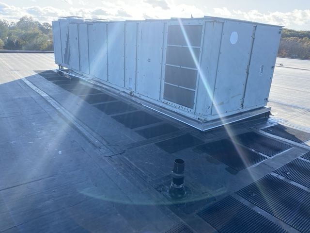 A large white box is sitting on top of a roof.
