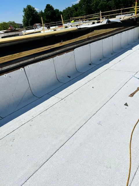 A white roof is being installed on a building