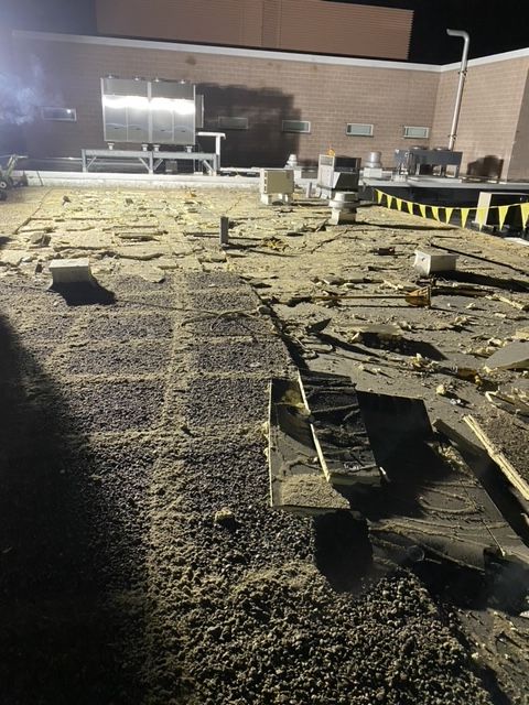 A brick building with a lot of dirt on the ground in front of it