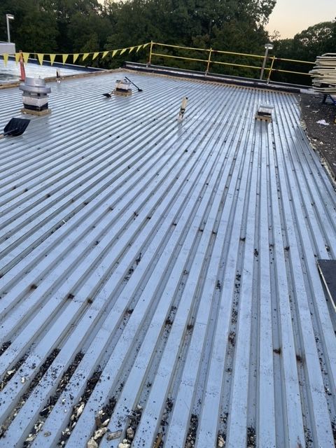 A metal roof with a yellow fence around it
