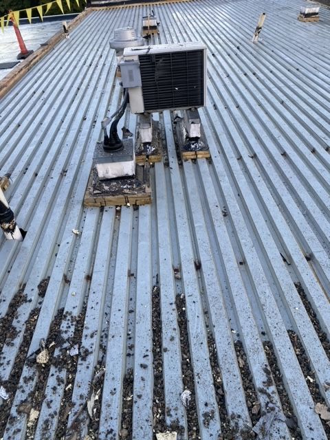A roof with roofing repair tools sitting on top of it