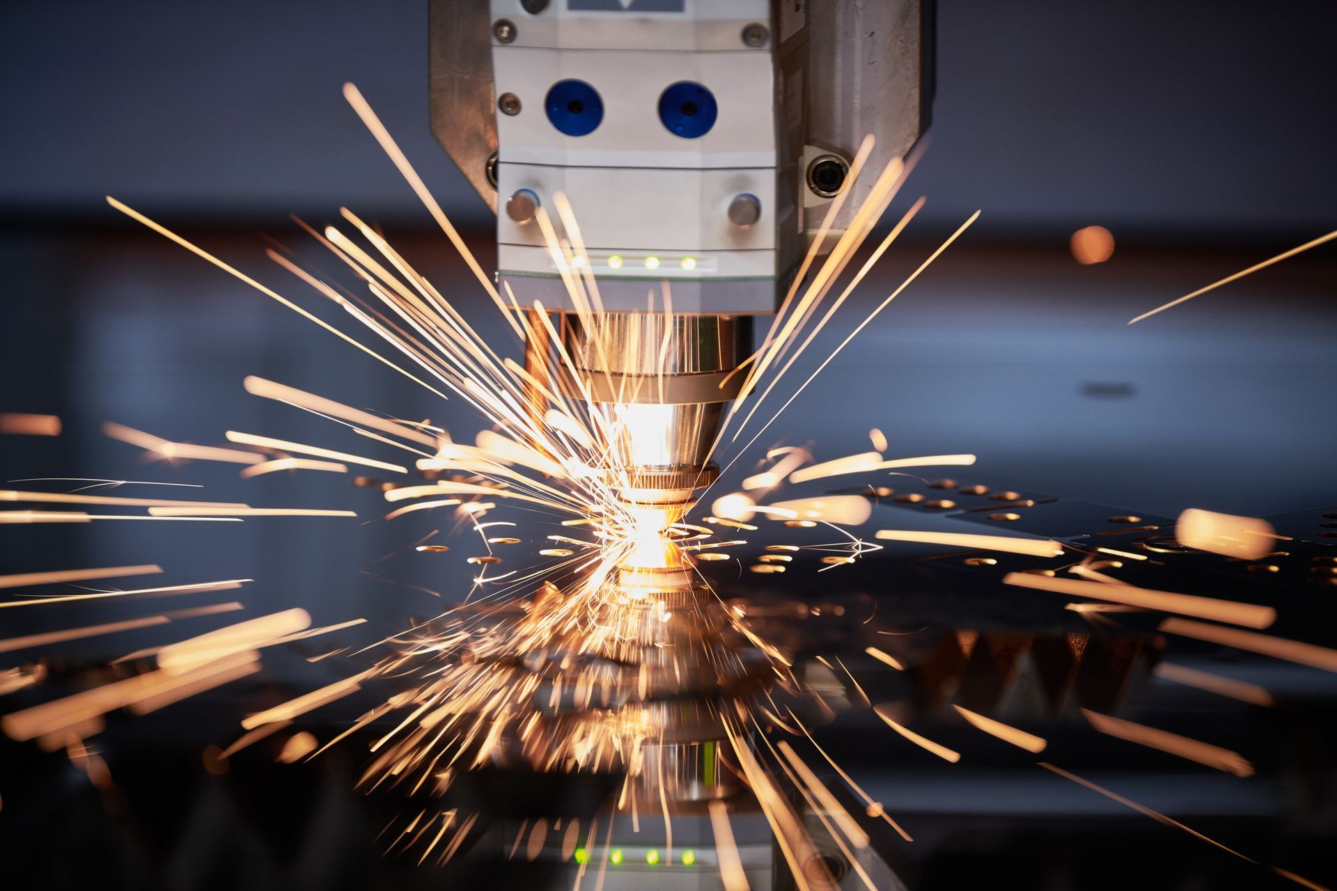 Laser cutting metal, sparks flying.