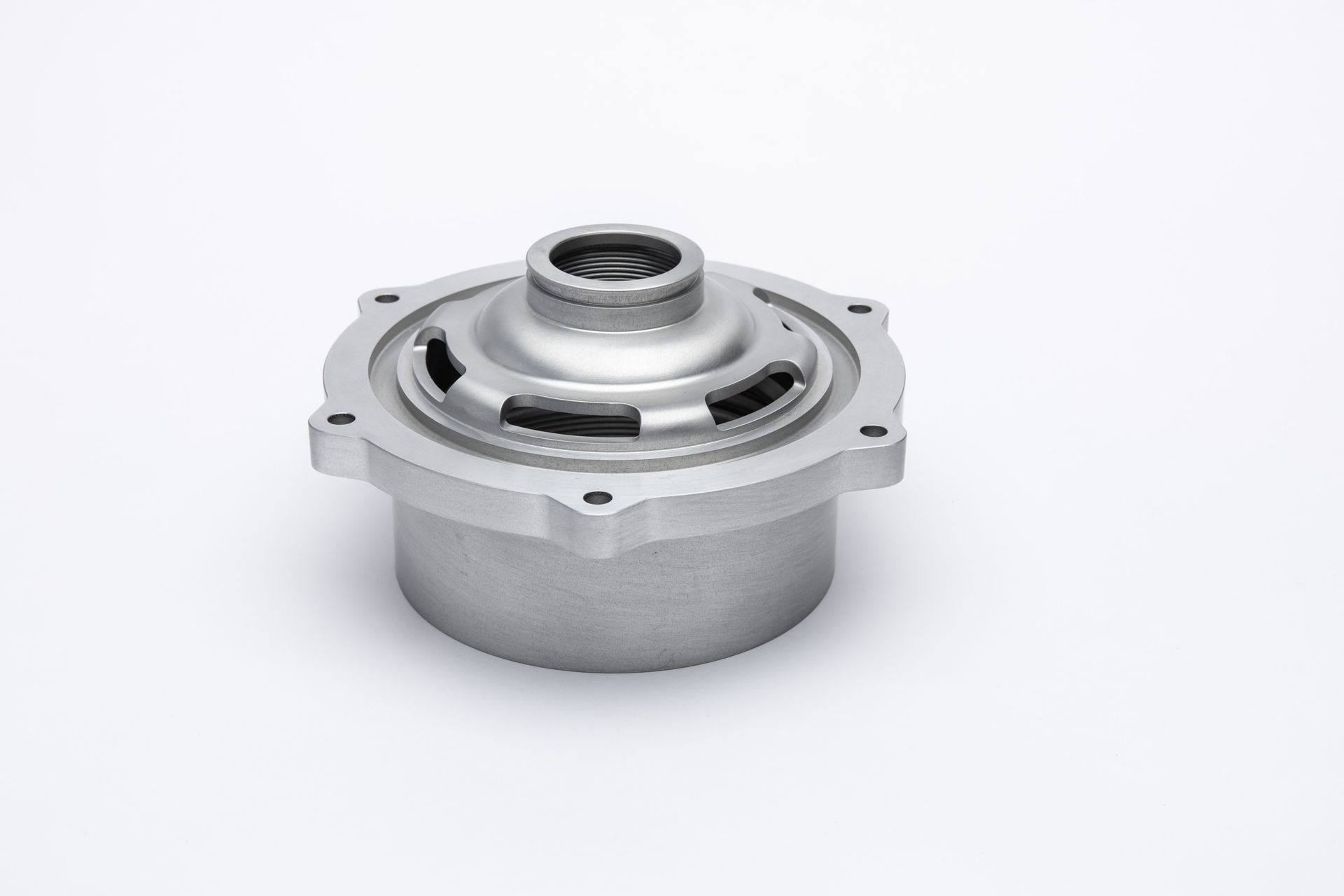 Silver metal part with a cylindrical base, circular top with holes, and a central opening, on a white background.