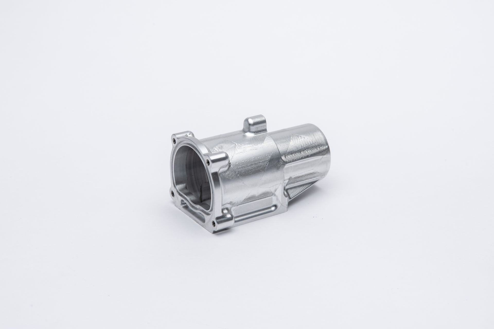 Metallic, cylindrical part with a boxy end, set against a white background.