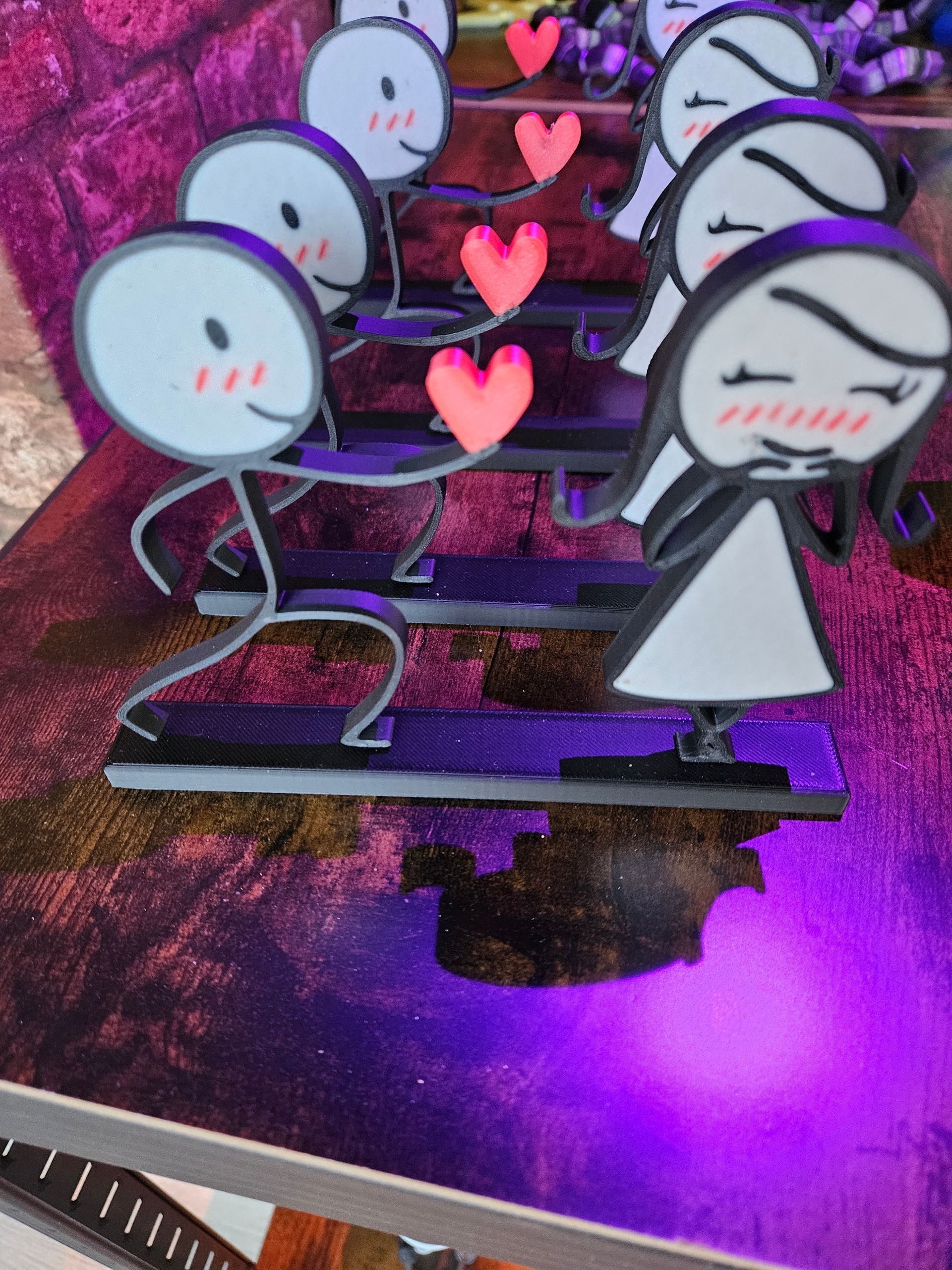 Stick figure couple on stairs with hearts, blushing. Purple and pink background.