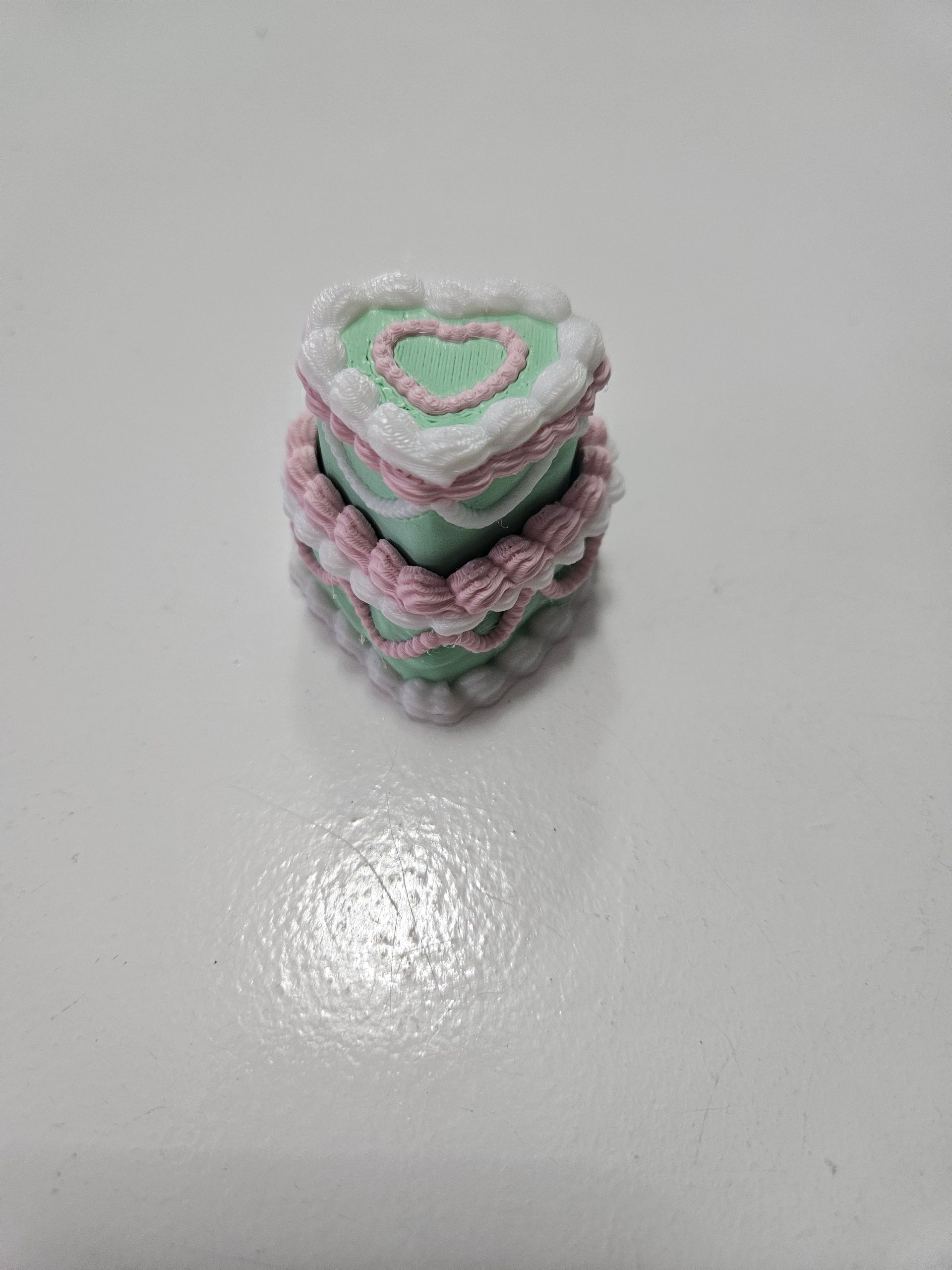 Small pastel knit stack of heart-shaped pieces on a white surface