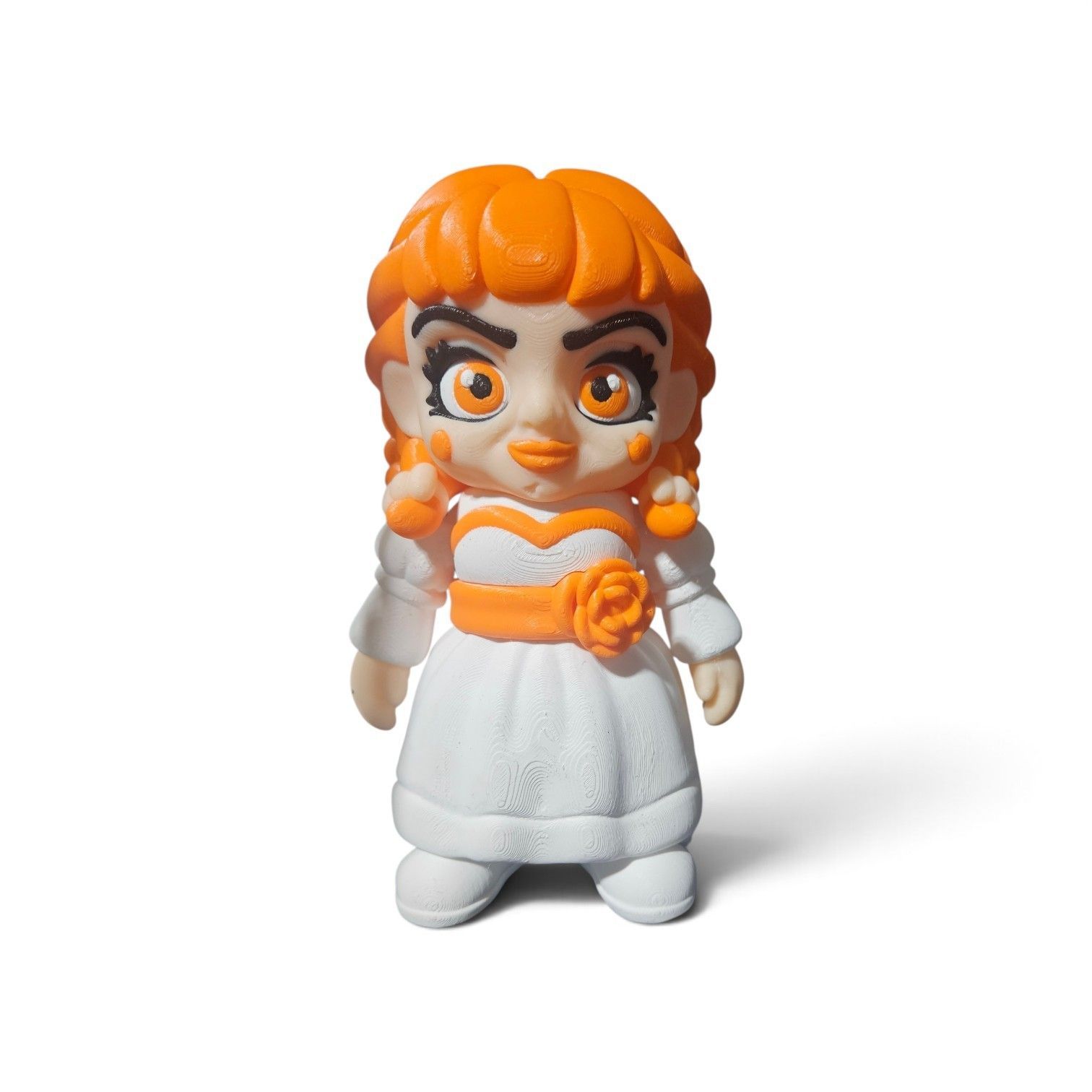 Orange-haired figurine in a white dress with orange scarf and flowers, standing on a white background