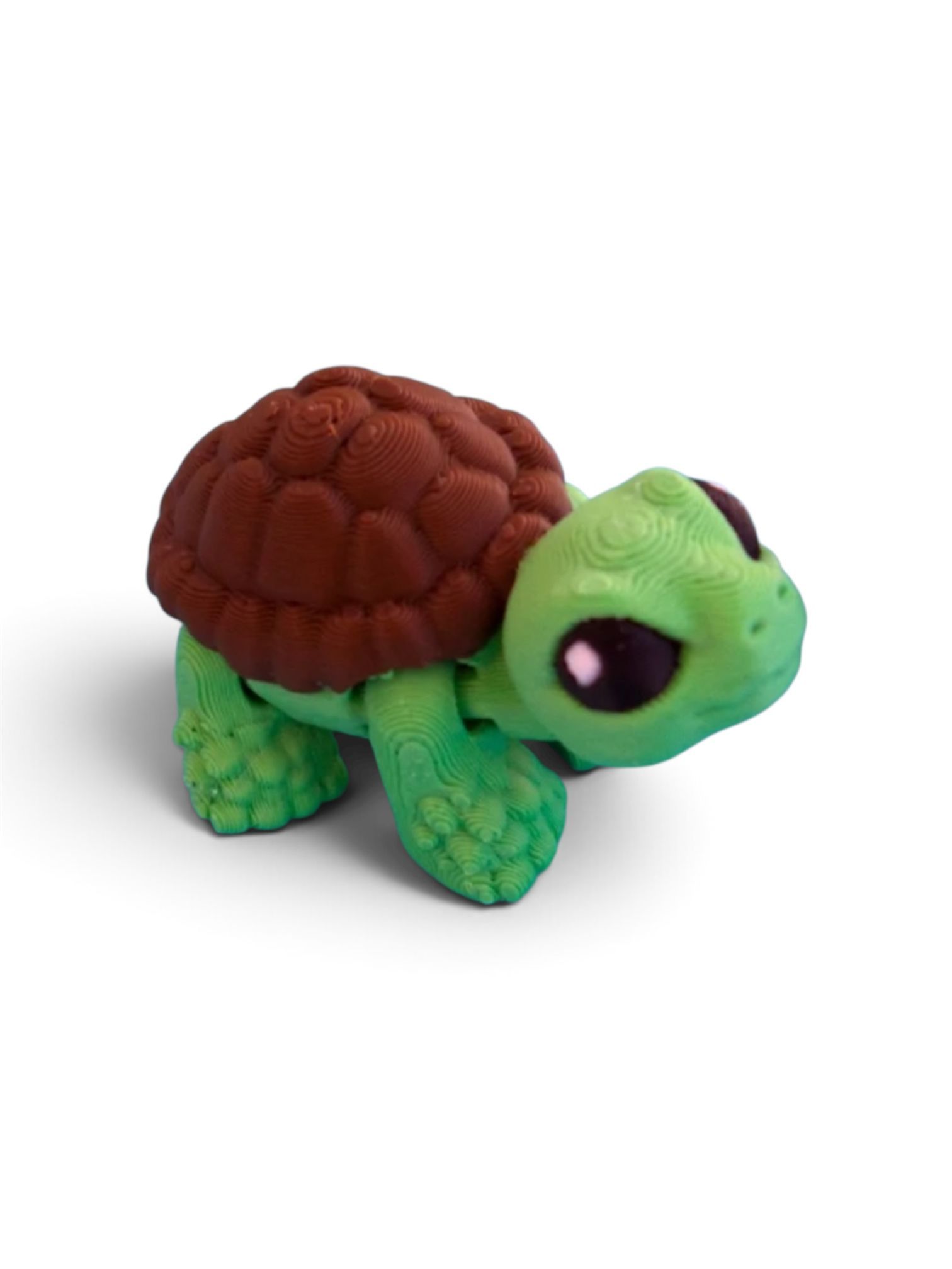 Small green turtle figurine with a brown shell on a white background